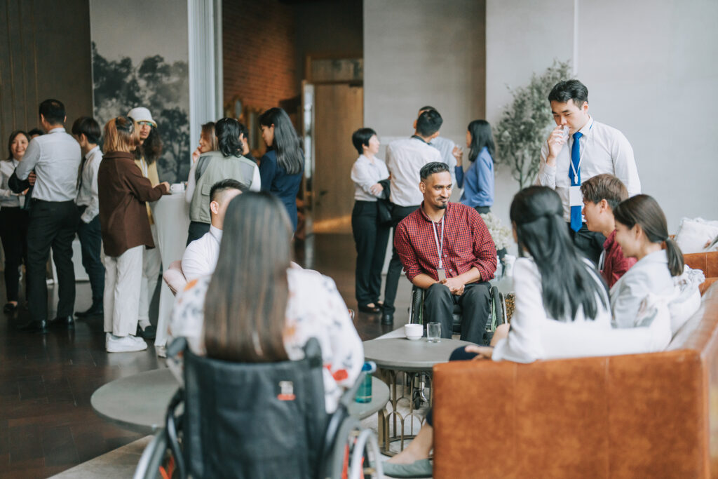 A group of people having a casual chat after a successful conference event at lounge