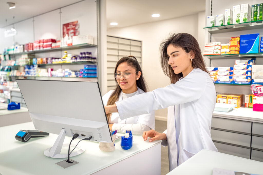 Two pharmacy workers at a computer